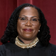 Associate Justice Ketanji Brown Jackson stands as she and members of the Supreme Court pose for a new group portrait following her addition, at the Supreme Court building in Washington, Friday, Oct. 7, 2022.